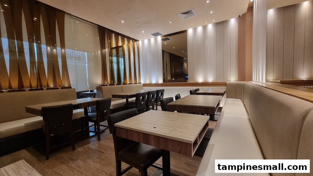 A spacious and modern dining area at Itacho Sushi with comfortable booth seating and tables.