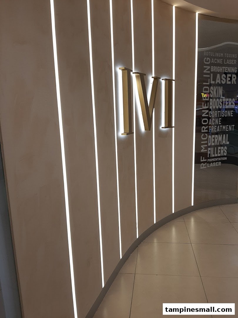 Modern facade of IVI Medical Clinic with illuminated logo and listed aesthetic services.
