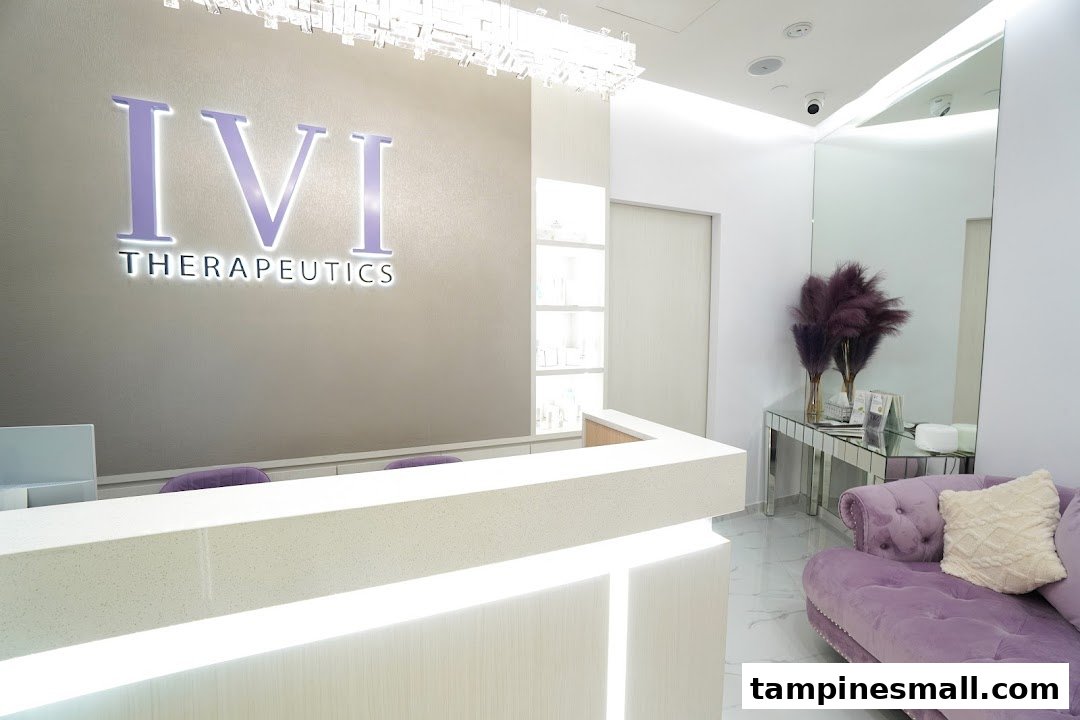 A bright, modern reception area with the 'IVI Therapeutics' logo, a white counter, and a purple velvet sofa.