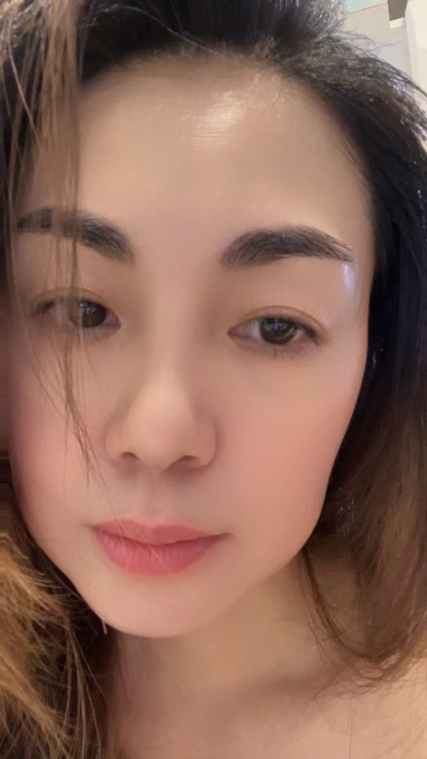 A close-up portrait of a person's face, highlighting clear skin and natural features.
