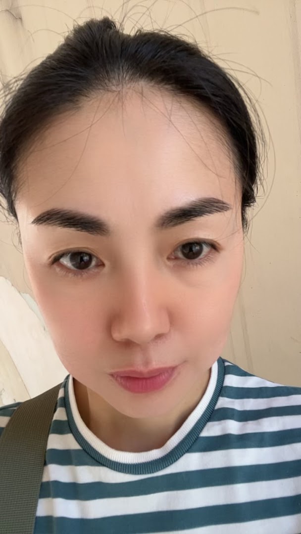 A close-up of a person's face, highlighting clear skin and well-groomed eyebrows.