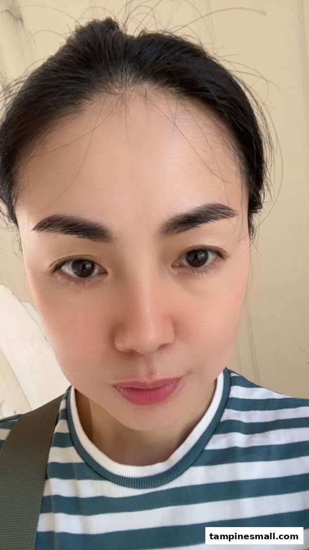 A close-up of a person's face, highlighting clear skin and well-groomed eyebrows.