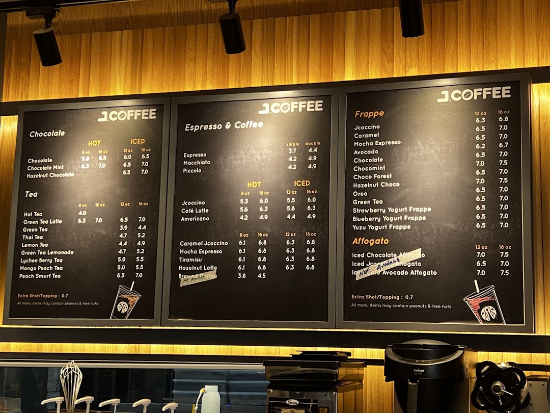 A detailed menu board displaying various coffee, tea, chocolate, frappe, and affogato options with prices and sizes.