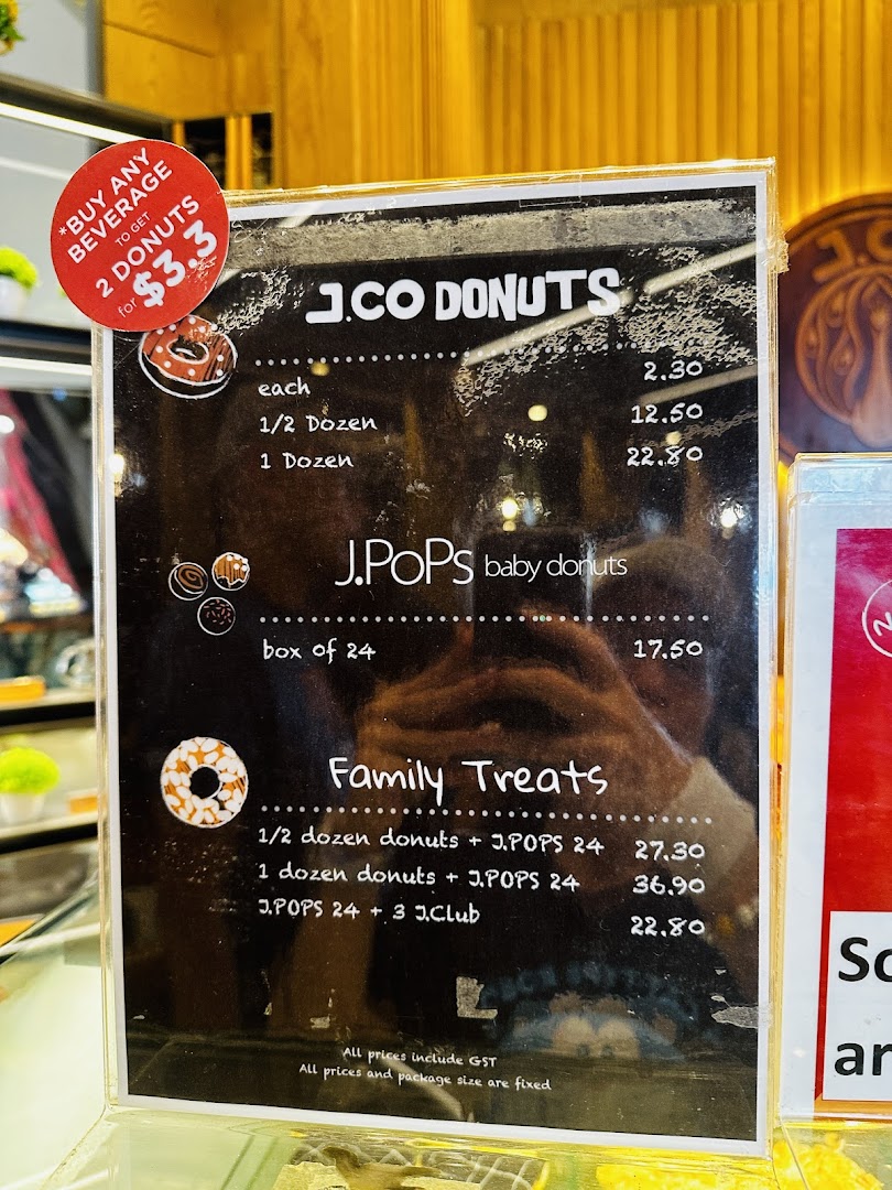 A menu board displaying prices for J.Co Donuts, J.Pops, and Family Treats, including a special offer.