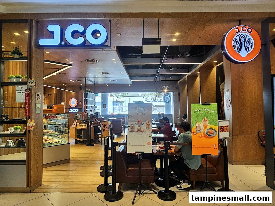 The inviting entrance of J.Co Donuts & Coffee, showcasing its interior and promotional displays.