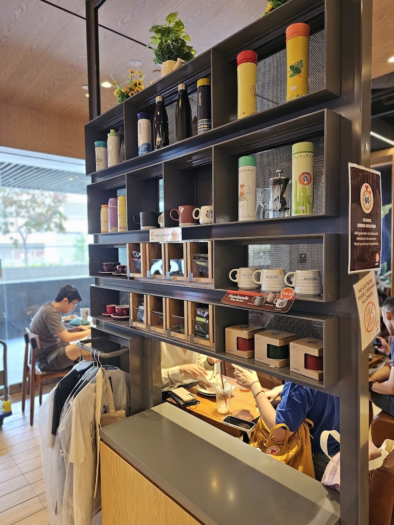 Interior view of J.Co Donuts & Coffee, showcasing merchandise and a bustling counter area.