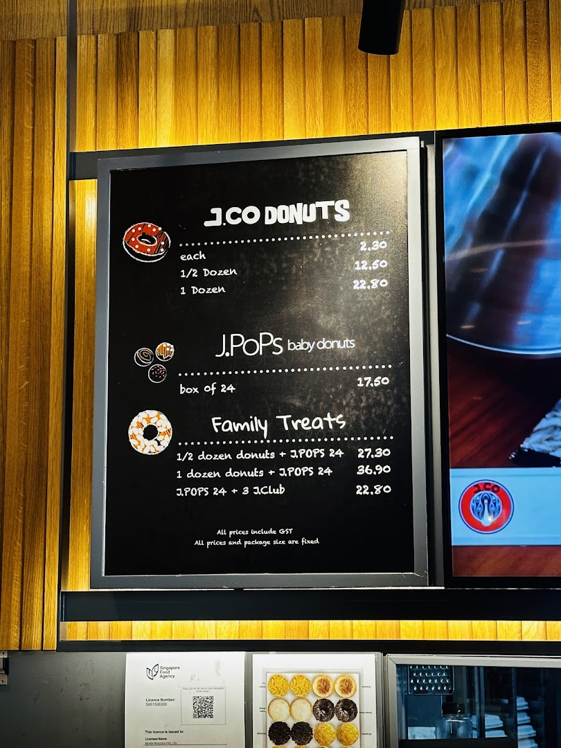 A menu board displaying prices for J.Co Donuts, J.Pops baby donuts, and family treats.