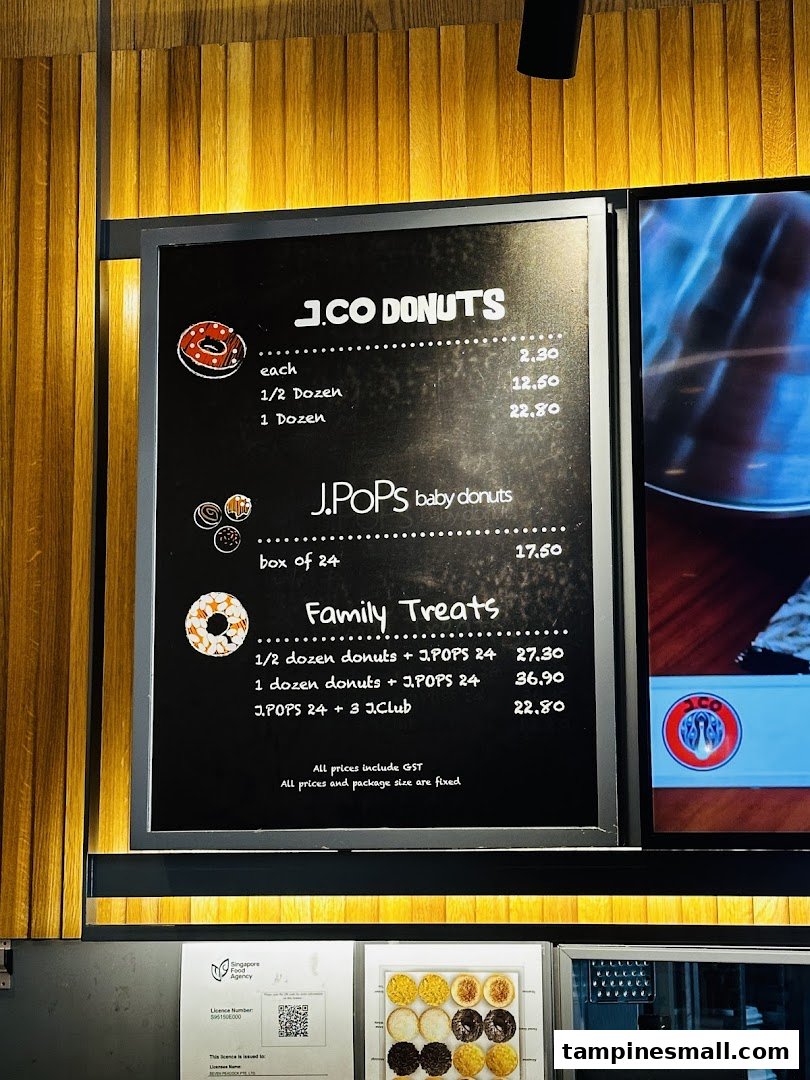A menu board displaying prices for J.Co Donuts, J.Pops baby donuts, and family treats.