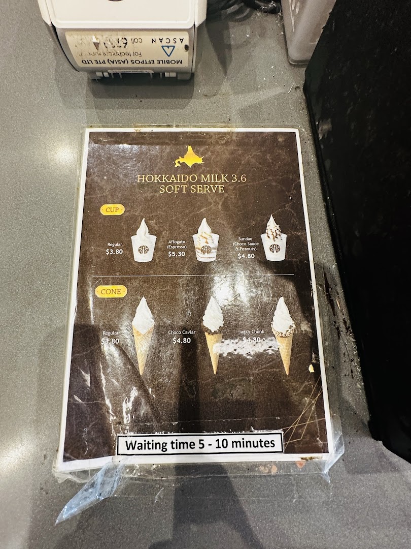 A menu displaying Hokkaido Milk 3.6 soft serve options in cups and cones with prices.