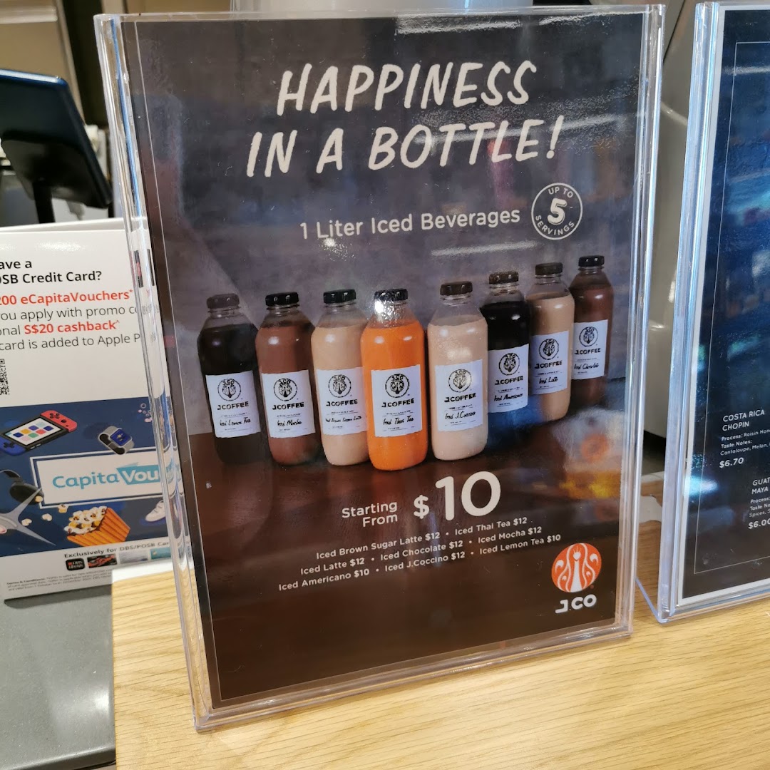 A display stand advertising J.Co's 1-liter iced beverages with prices and flavors.