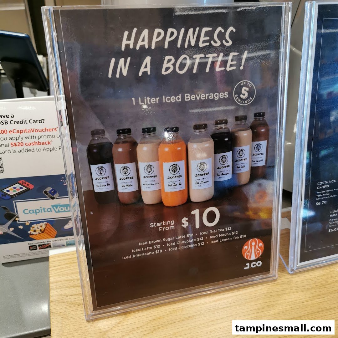 A display stand advertising J.Co's 1-liter iced beverages with prices and flavors.