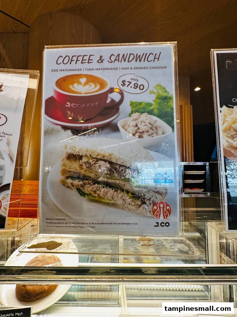 A promotional display for J.Co's Coffee & Sandwich combo featuring various sandwich options for $7.90.