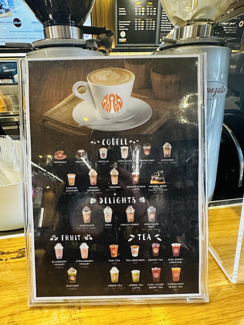 A close-up of J.Co Donuts & Coffee's beverage menu, featuring various coffee, delight, fruit, and tea options.