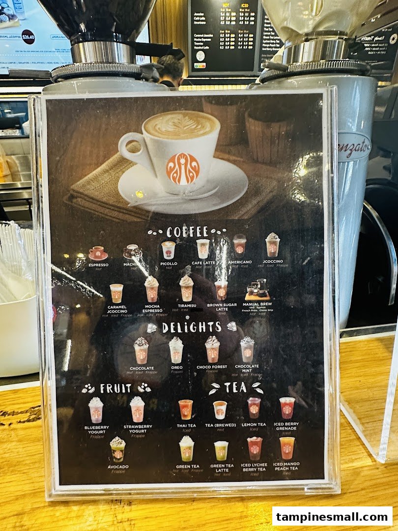 A close-up of J.Co Donuts & Coffee's beverage menu, featuring various coffee, delight, fruit, and tea options.