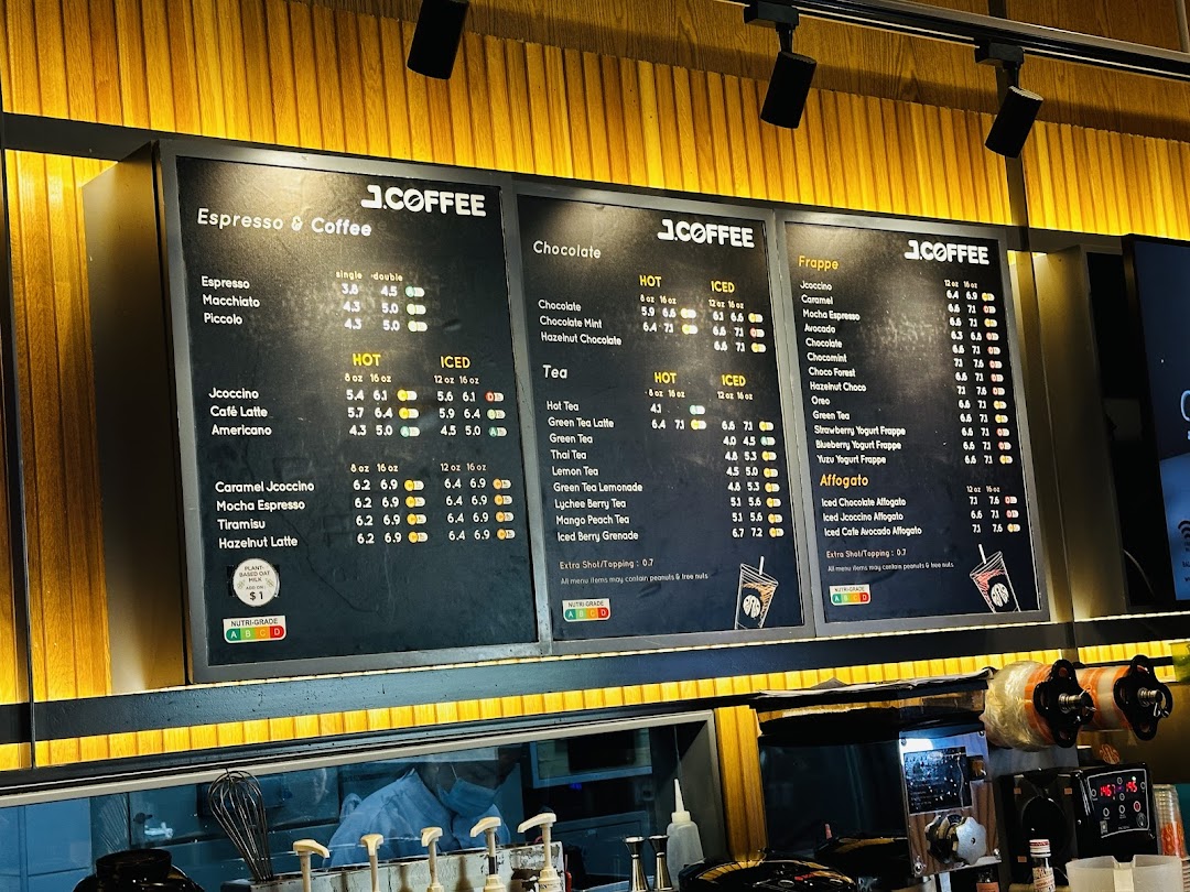 Multiple menu boards displaying coffee, chocolate, tea, and frappe options at J.Co Donuts & Coffee.