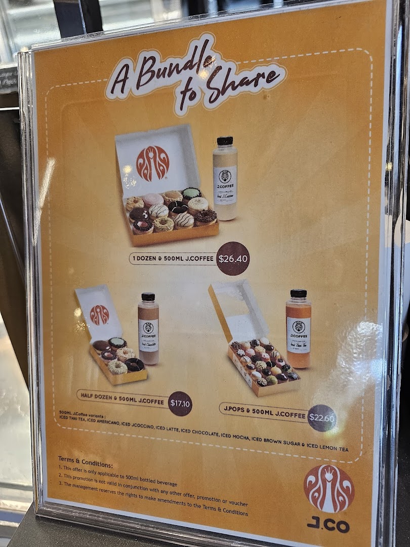 A promotional menu board displaying J.Co Donuts & Coffee bundle deals with donuts and bottled coffee.