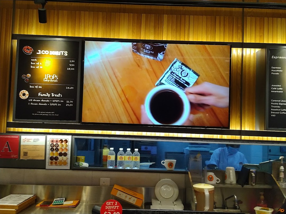 A digital menu board displaying donut and coffee options at J.Co Donuts & Coffee.