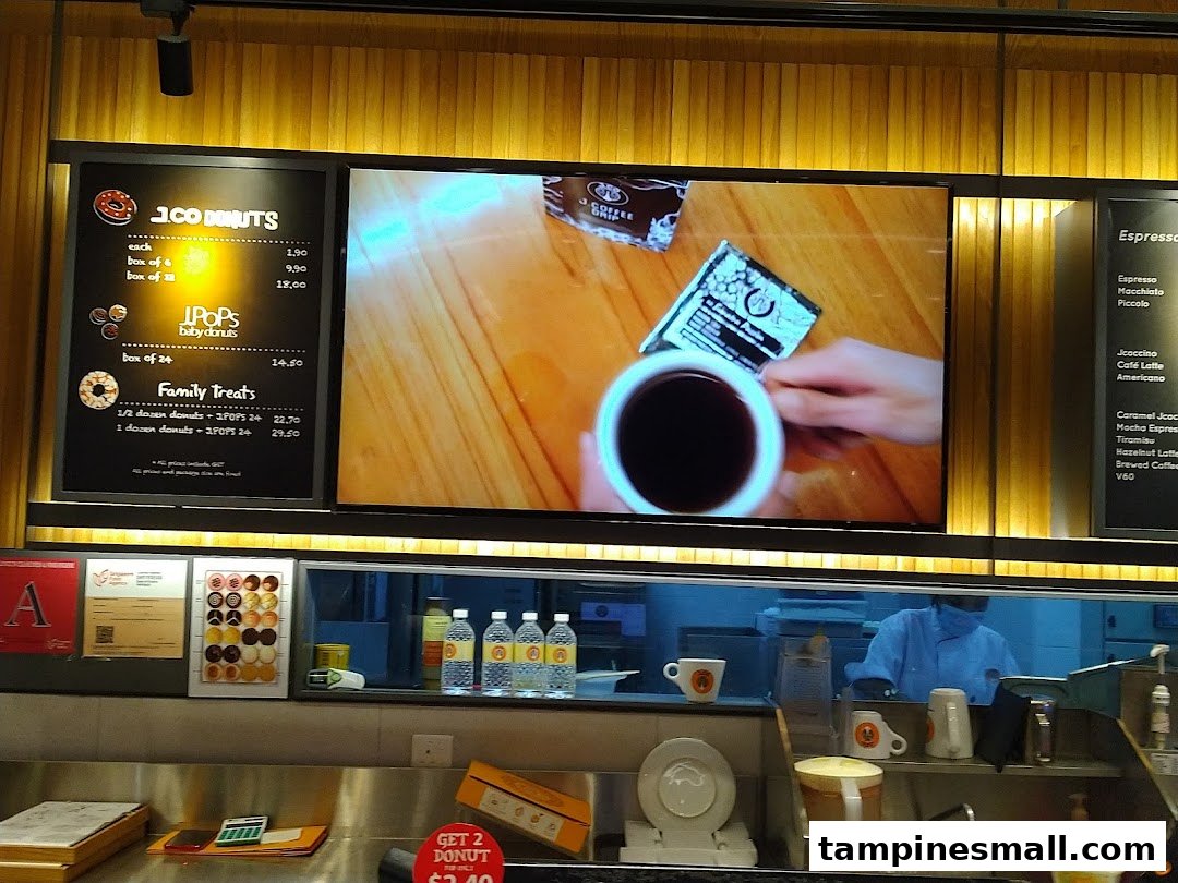 A digital menu board displaying donut and coffee options at J.Co Donuts & Coffee.
