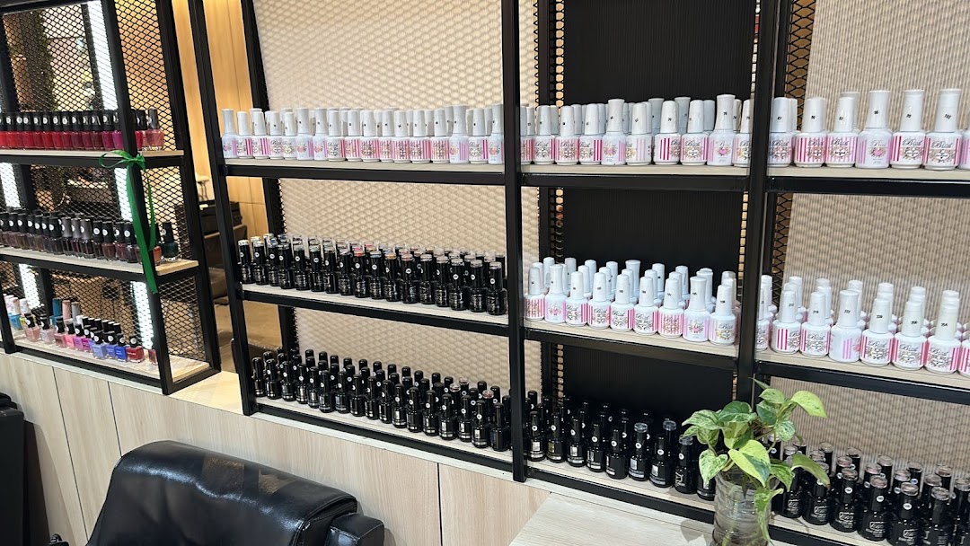 Shelves displaying a wide variety of nail polish bottles in a beauty salon.