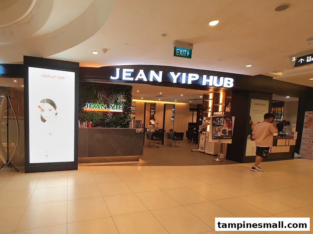 The brightly lit entrance of Jean Yip Hub, a hair and beauty salon, with a prominent sign.