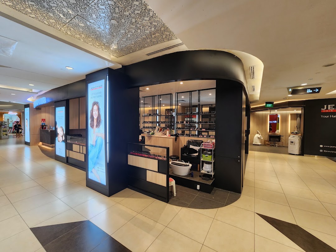 The modern shopfront of Jean Yip Hairdressing and Beauty, showcasing its services and inviting entrance.