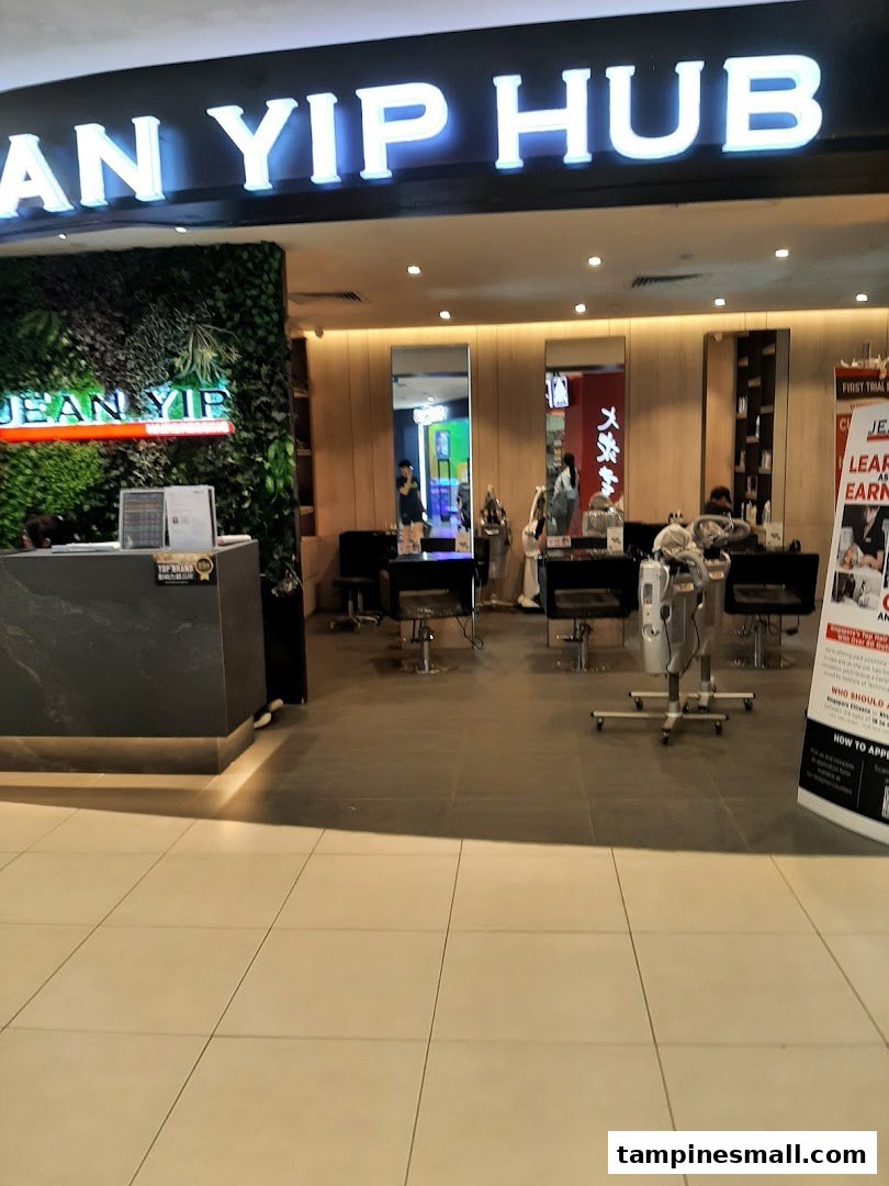 Entrance of Jean Yip Hairdressing and Beauty Tampines Mall with a green wall and reception area.