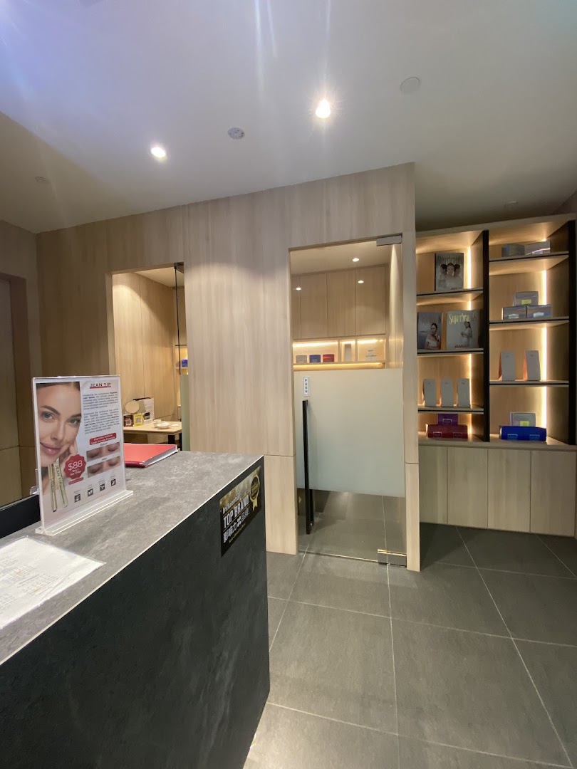 Interior view of Jean Yip Hairdressing and Beauty reception area with product display shelves.