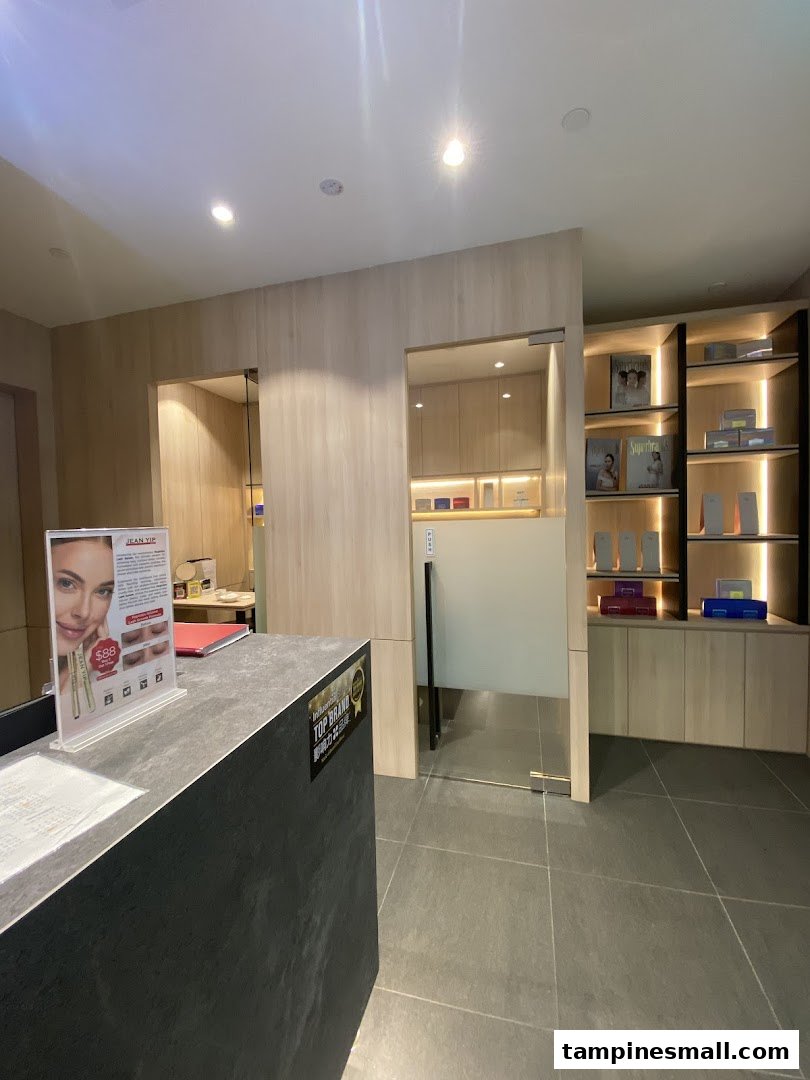Interior view of Jean Yip Hairdressing and Beauty reception area with product display shelves.