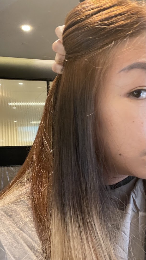 Close-up of a person's hair showing different shades, likely during a hair treatment or coloring process.