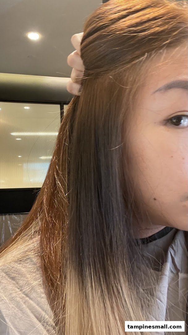 Close-up of a person's hair showing different shades, likely during a hair treatment or coloring process.