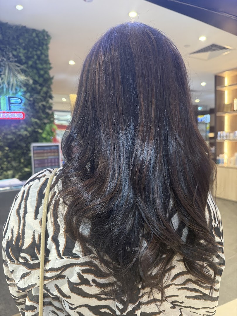 Back view of a person showcasing freshly styled, dark wavy hair at Jean Yip.