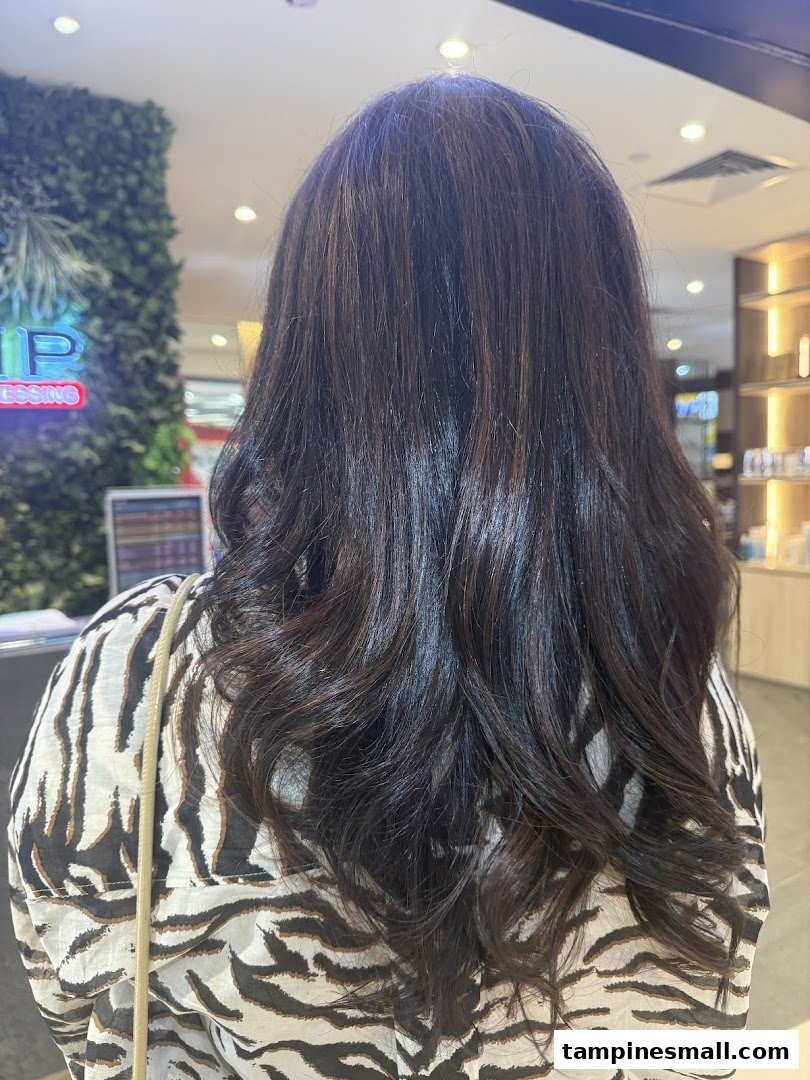 Back view of a person showcasing freshly styled, dark wavy hair at Jean Yip.
