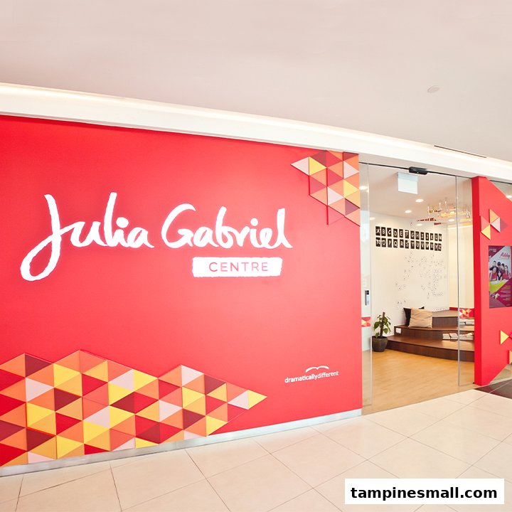 The bright red entrance of Julia Gabriel Centre with its prominent logo and glass doors.