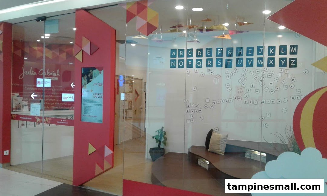 The vibrant storefront of Julia Gabriel Centre, an education facility, featuring colorful decor and alphabet displays.