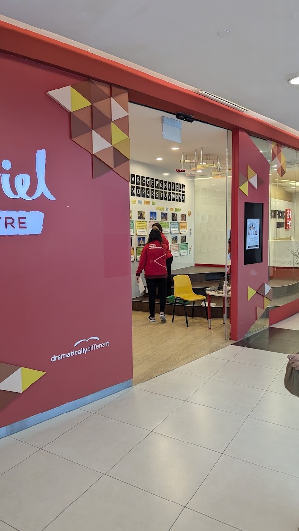 The entrance of Julia Gabriel Centre, an education provider, with staff and learning materials visible inside.
