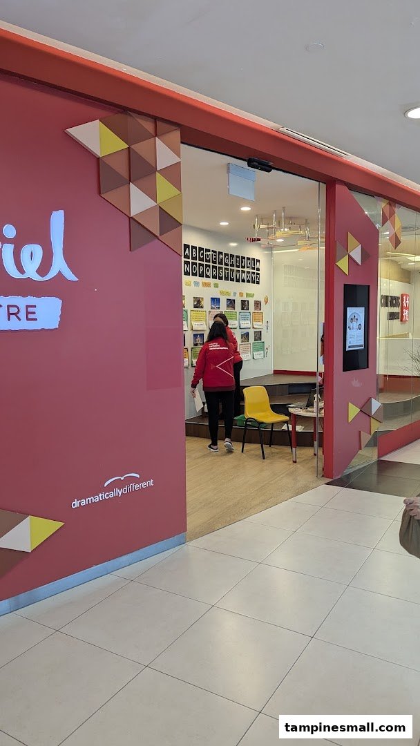 The entrance of Julia Gabriel Centre, an education provider, with staff and learning materials visible inside.