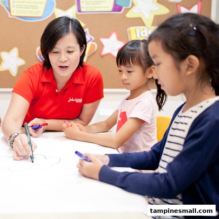 An instructor guides two children in a creative activity at Julia Gabriel Centre.
