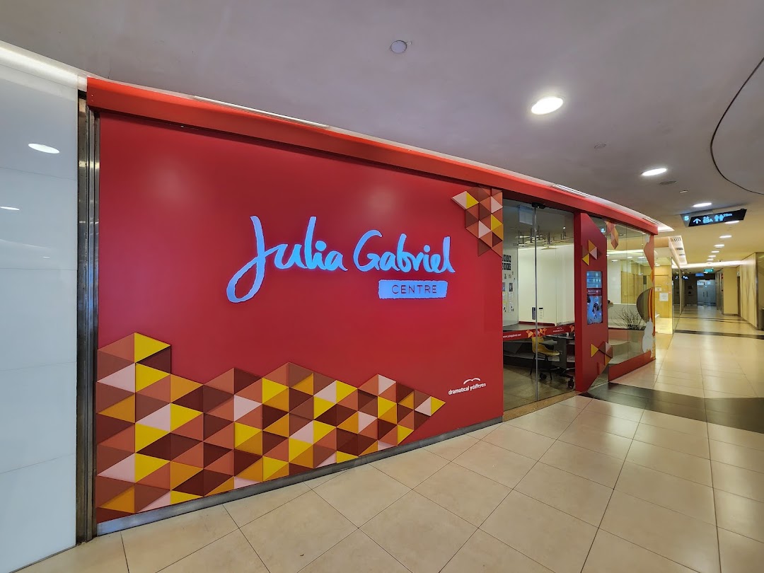 The vibrant red shop front of Julia Gabriel Centre with its distinctive logo and geometric patterns.