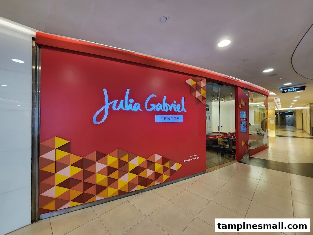 The vibrant red shop front of Julia Gabriel Centre with its distinctive logo and geometric patterns.