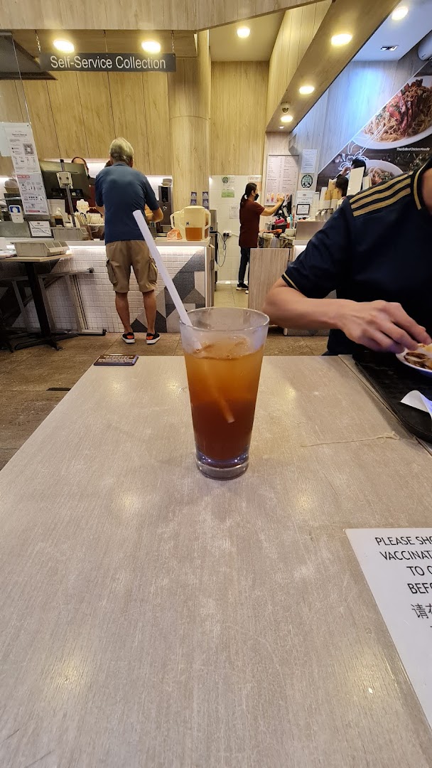 Interior view of Kaffe & Toast, featuring a drink on a table and customers at the counter.