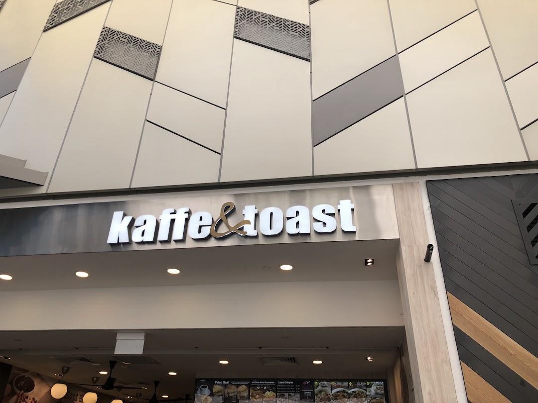 The shopfront of Kaffe & Toast, featuring its prominent logo and modern mall architecture.