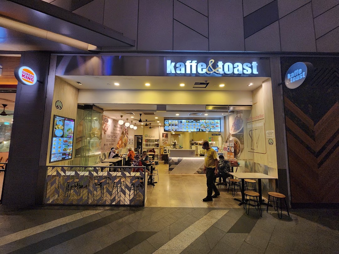 Exterior view of Kaffe & Toast, showcasing its entrance, interior, and outdoor seating area.