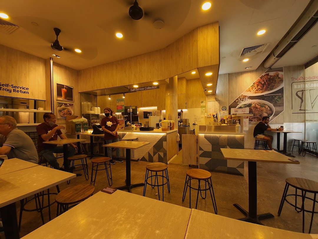 An inviting interior shot of Kaffe & Toast cafe, showing customers, staff, and the service counter.