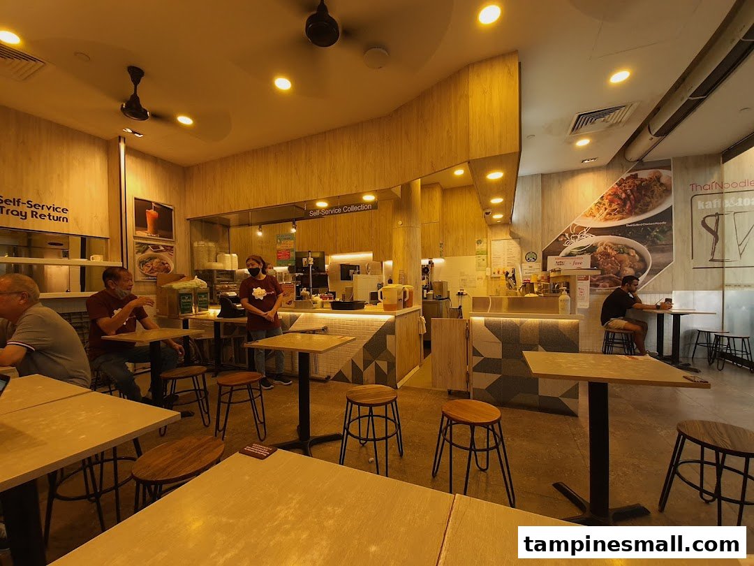 An inviting interior shot of Kaffe & Toast cafe, showing customers, staff, and the service counter.