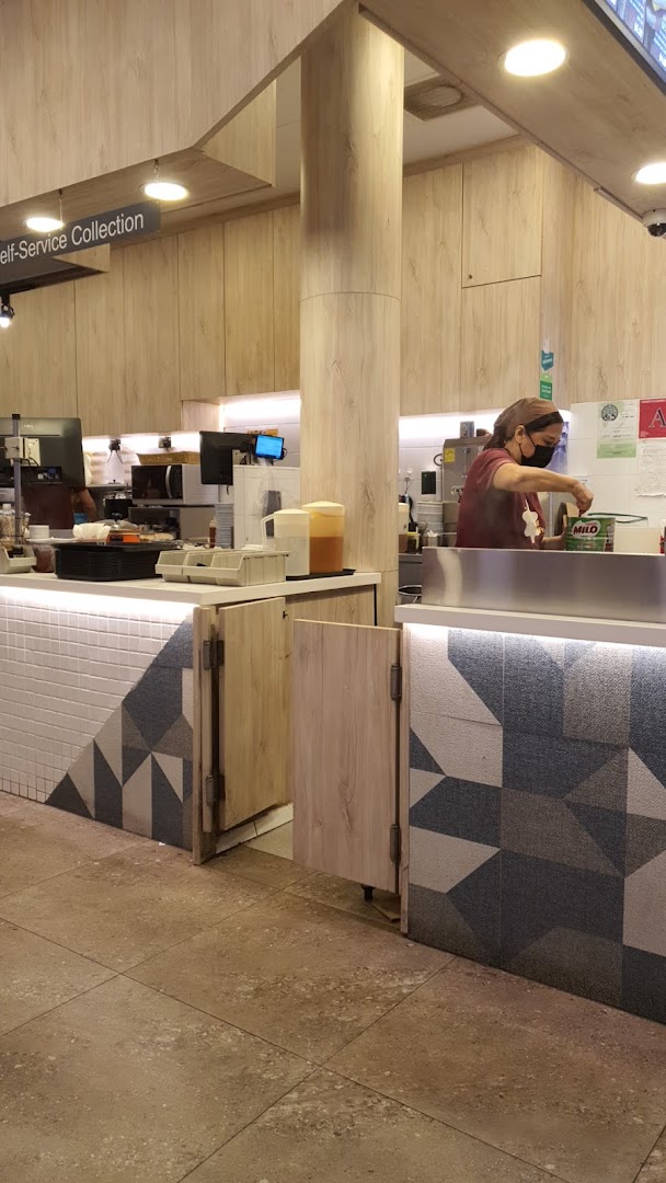 A staff member prepares drinks behind the counter at Kaffe Toast Tampines Ctrl 5.
