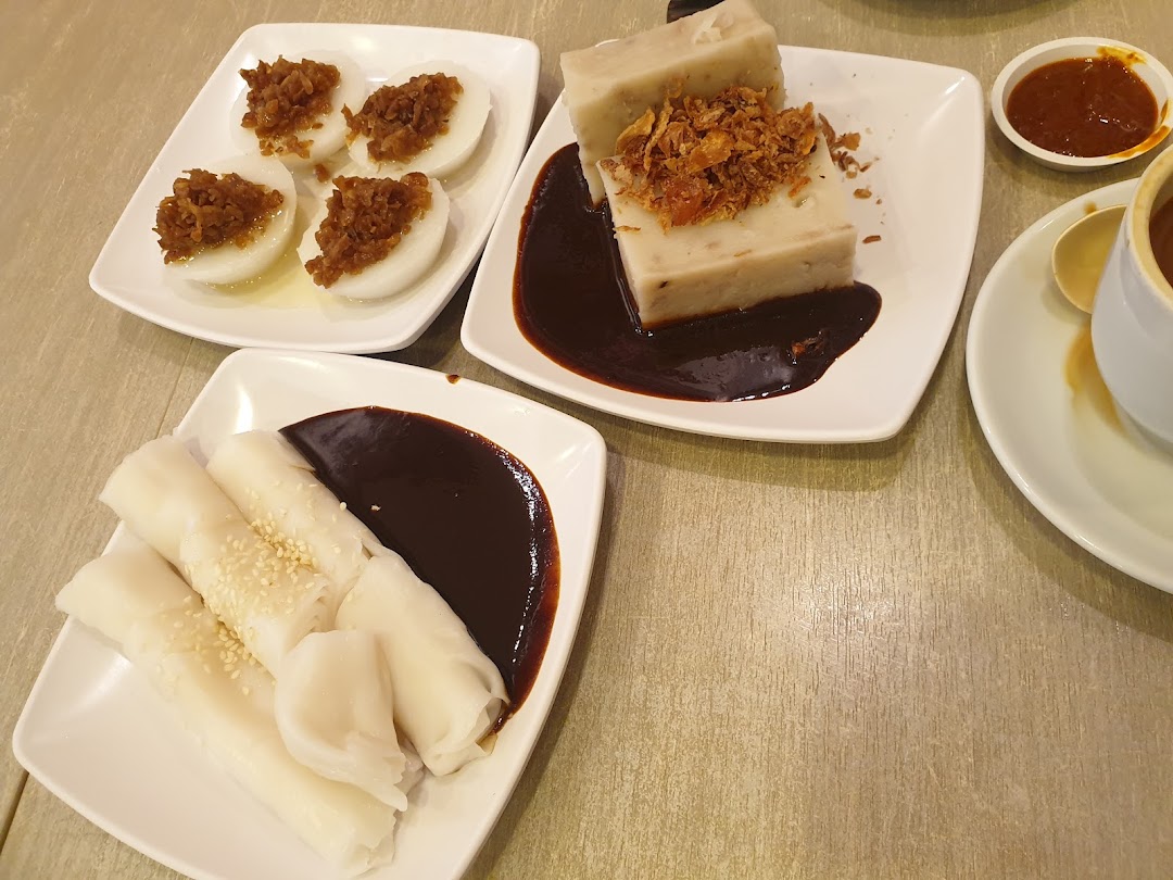 A delightful spread of traditional Asian snacks including chwee kueh, yam cake, and chee cheong fun.