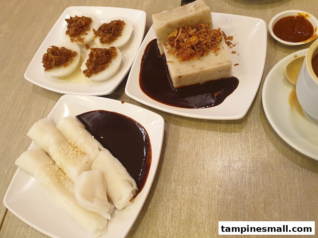 A delightful spread of traditional Asian snacks including chwee kueh, yam cake, and chee cheong fun.