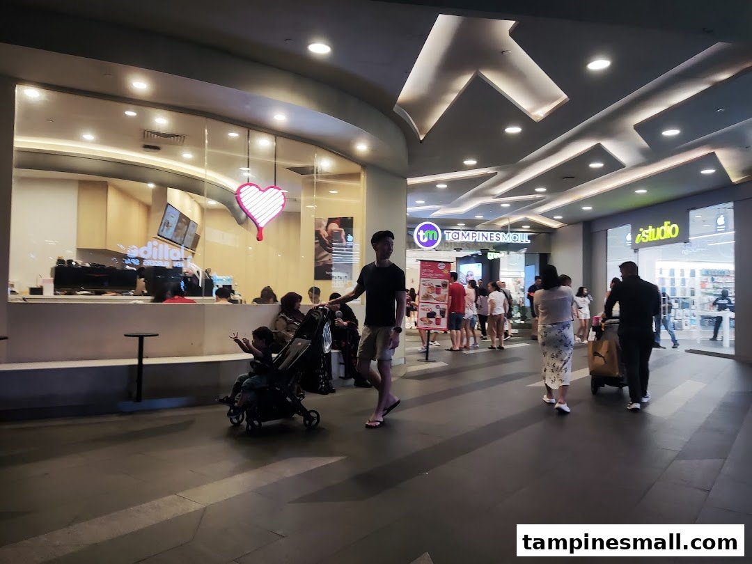 Exterior view of Kenangan Coffee at Tampines Mall, showing its entrance and a vibrant mall corridor.