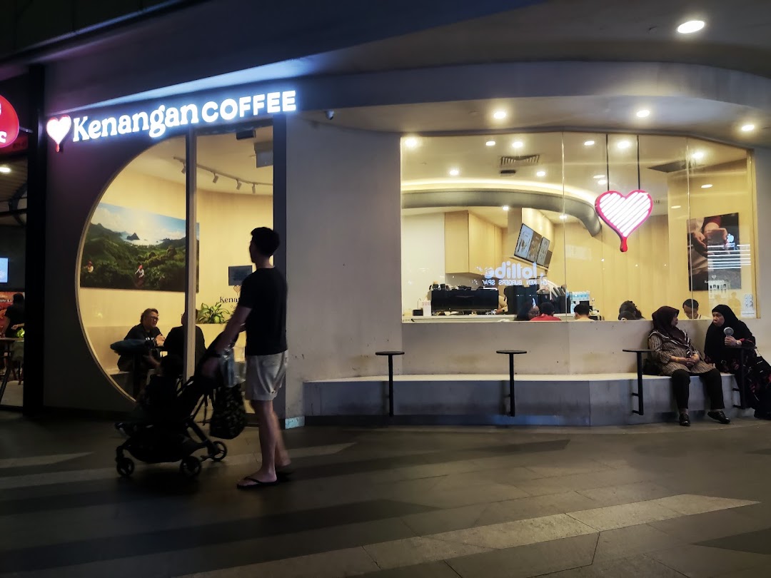 Exterior view of Kenangan Coffee at Tampines Mall, featuring its distinctive heart logo and inviting facade.