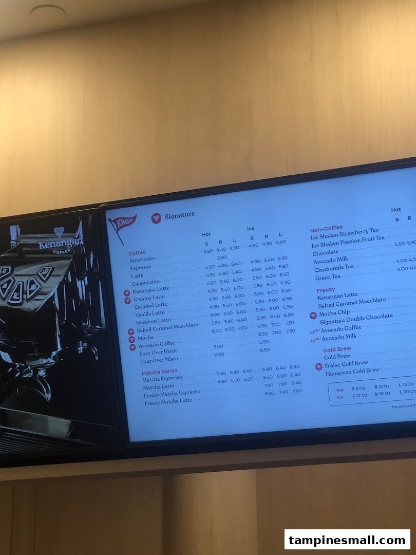 A digital menu board displaying various coffee, non-coffee, matcha, and cold brew options with prices.